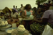 Woman sells cassava flour at roadside market