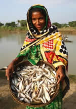 A woman displaying her catch of small fish