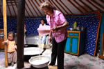 Togtohjargal, a member of a herders’ group in Ikhtamir village, in her house pouring milk 