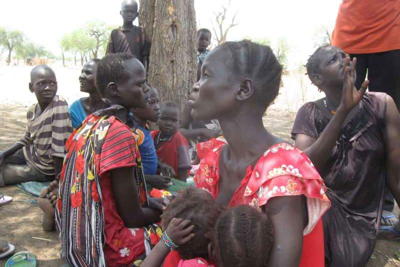 Displaced women and children under a hot sun in South Sudan&#39;s Maban County, where food shortages are causing tension. These people are predominantly smallholder farmers who have lost their livestock, even their farming tools.Photo: UNHCR\/P. Rulashe